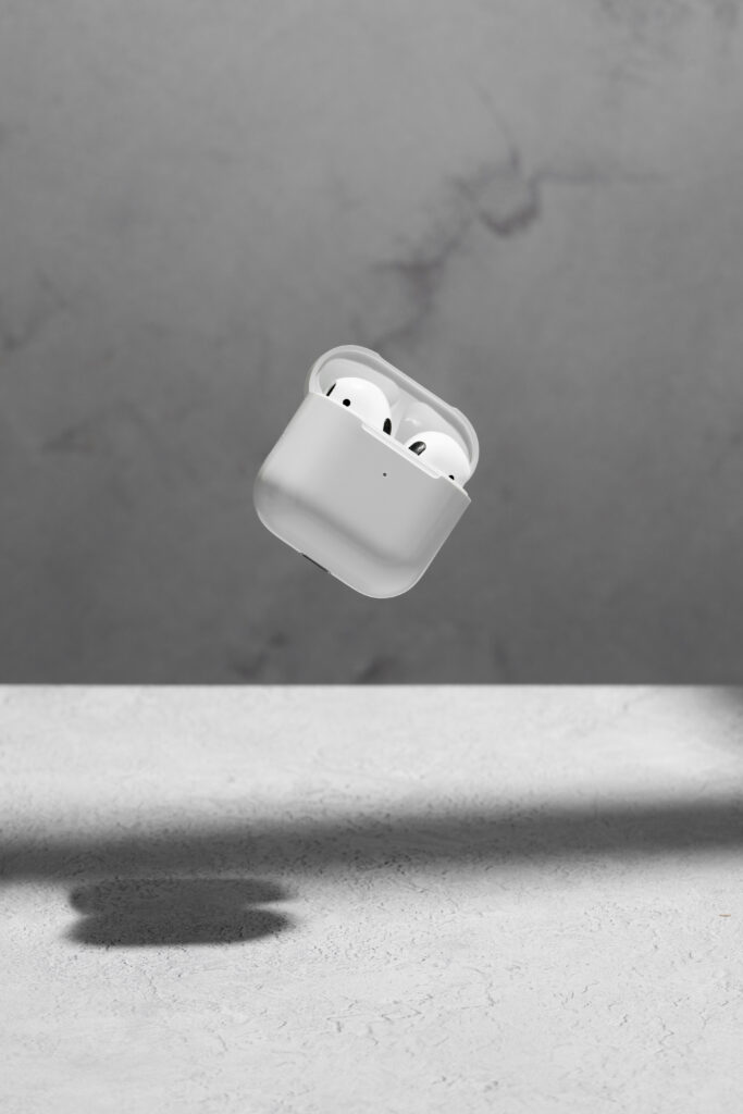 Best apple Airpods repairing center in Kathmandu floating modern wireless earphones with concrete background 1